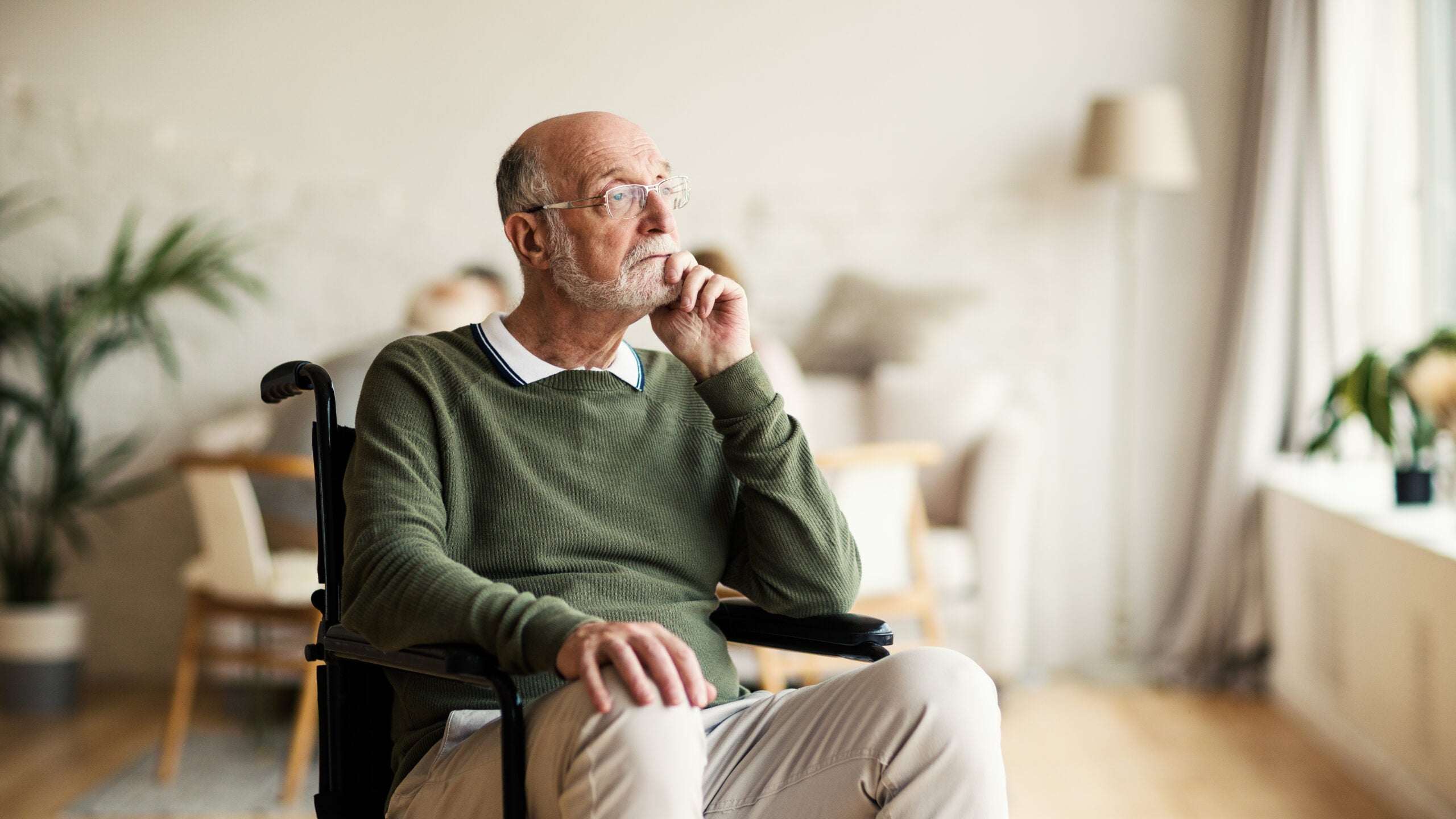 Disabled senior man thinking in nursing home